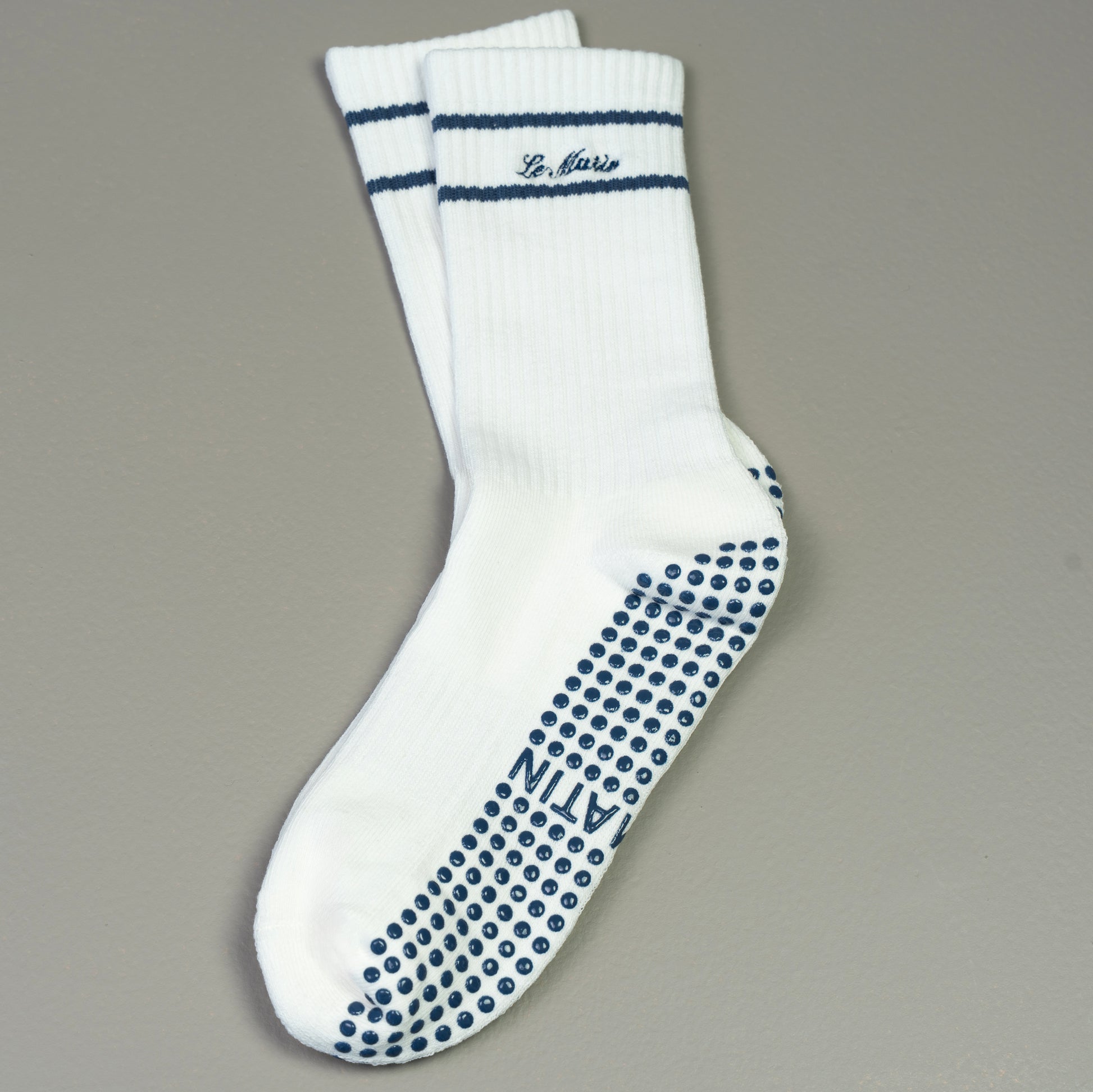 Blue navy socks and Le Matin branding  text on a gray background